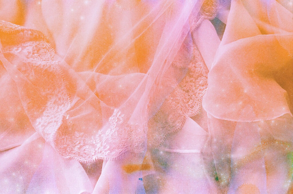 unique wedding film photography, Vermont wedding photographer, Lillian Seibert with Gold Wing Photography. Selkie dress and veil photographed on film soup roll creating a pink and orange galaxy effect. 